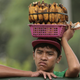 A Filipino boy selling boiled bananas rests on a steel fence in Quezon city, north of Manila, Philippines on Wednesday, Sept. 11, 2013. (AP Photo/Aaron Favila